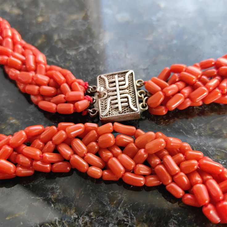 When ordering, please give us your phone number for safer Fedex shipping! Length: 46 cm Metal Type: Silver Weight: 52 grams Stones: coral Condition: Excellent This stunning vintage necklace from the 1940s china  is a rare find for anyone who appreciates the beauty and elegance of the past. Crafted from natural coral, this necklace features smooth beads that have a vibrant orange-red hue. The necklace is secured with a silver lock that adds a touch of oriental allure and ensures a comfortable fit. Own a piece of this era where artistry and craftsmanship were paramount. Whether you are looking for a gift for a loved one, or a treat for yourself, this necklace is sure to impress and delight.   Your item will come boxed, carefully wrapped and sent insured by Fedex priority Mail. When ordering, Luxury Red Coral Jewelry With Polished Beads, Vintage Red Coral Round Bead Necklaces, Vintage Red Coral Round Bead Necklace, Vintage Red Coral Necklace With Round Beads, Vintage Single Strand Red Coral Beaded Necklace, Vintage Red Coral Single Strand Beaded Necklace, Vintage Coral Beaded Necklaces In Red Coral, Vintage Single Strand Red Coral Beaded Necklaces, Vintage Coral Beaded Necklaces