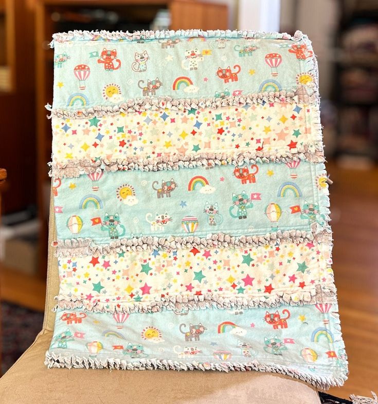 a baby blanket sitting on top of a chair