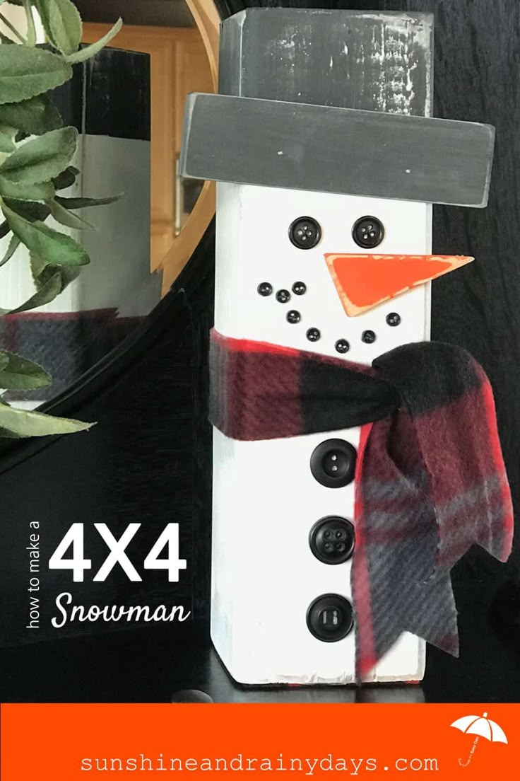 a snowman made out of wood and some black buttons