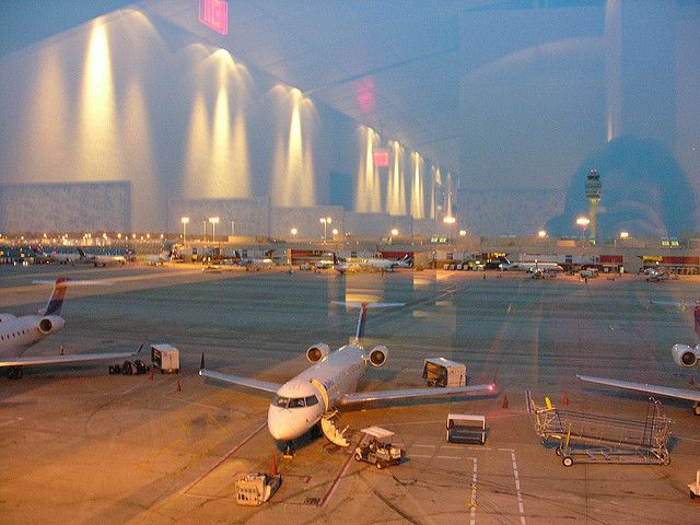 an airplane is parked on the tarmac at night