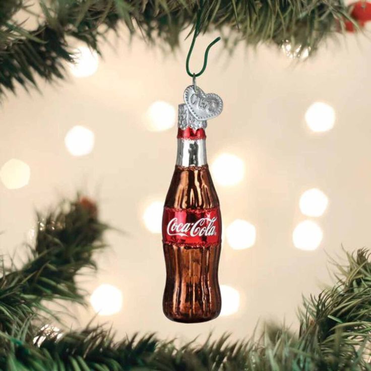 an ornament shaped like a coca cola bottle hanging from a christmas tree