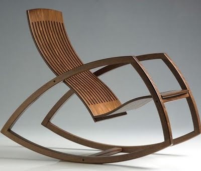 a modern rocking chair with wooden slats on the back and seat, designed to look like an abstract piece of art