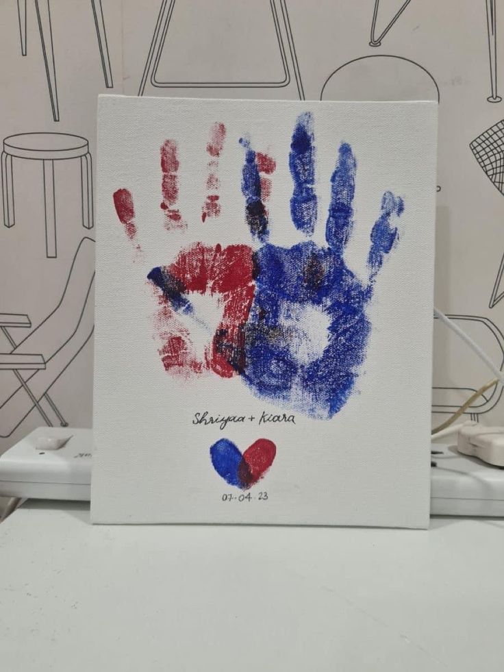 a handprint with the colors of france and england on it is displayed in front of a wall