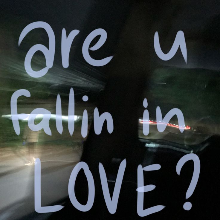 a sign that says are you falling in love? on the side of a car