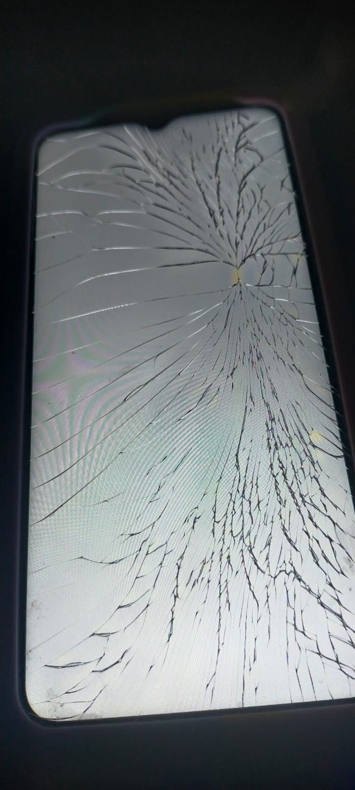 a broken cell phone screen sitting on top of a table