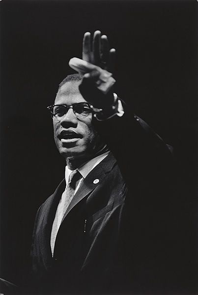 a black and white photo of a man holding a microphone