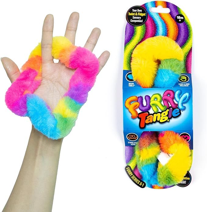 a hand is holding a fuzzy toy in it's palm and next to the package