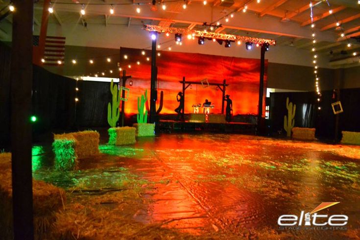 an empty dance floor is lit up with green and red lights