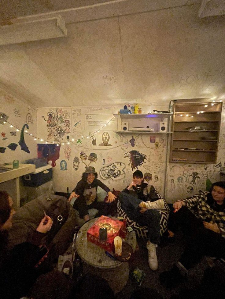 group of people sitting on couches in room with wallpapered walls and ceiling