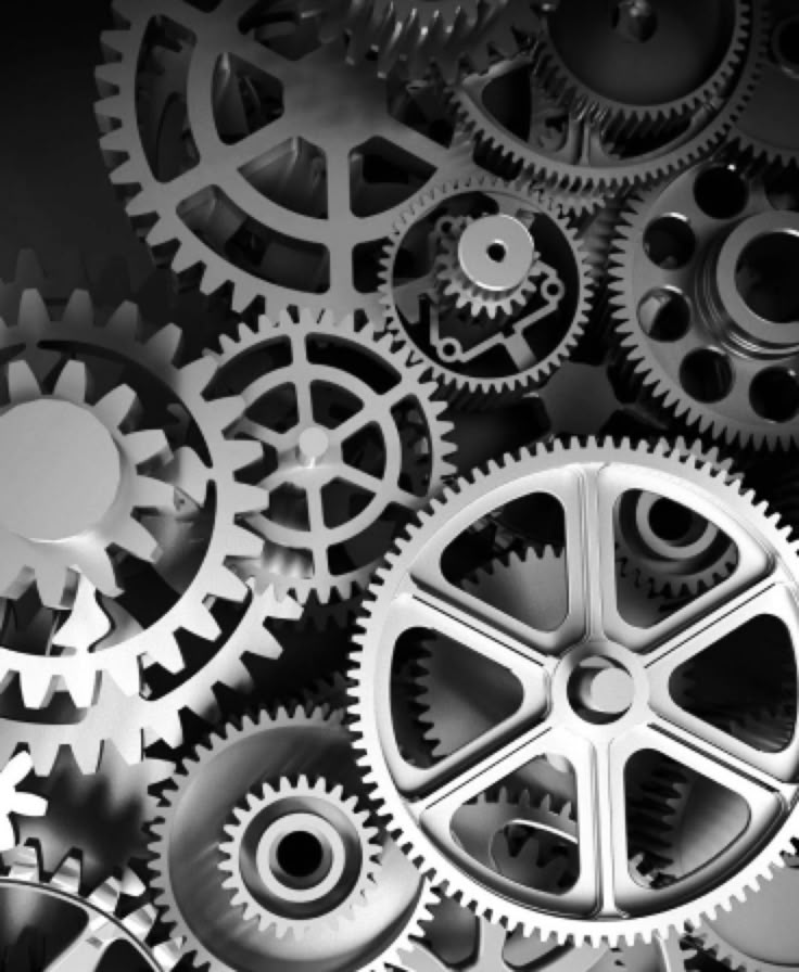 many different gears are shown together in this black and white photo, with the focus on the center gear