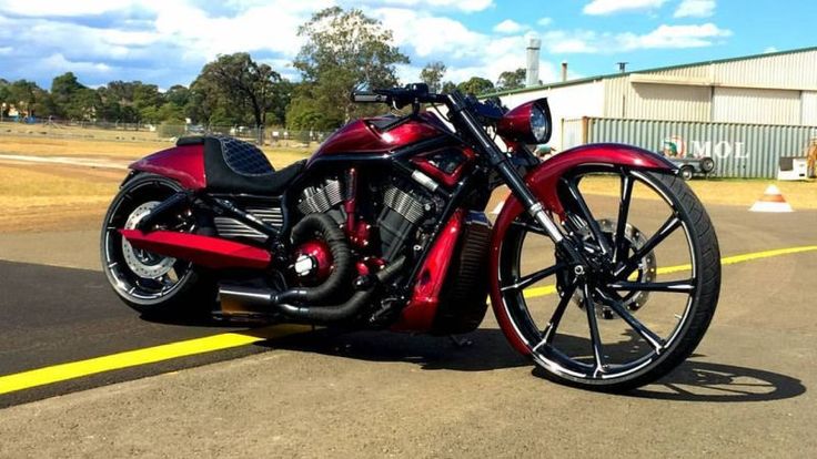 a red and black motorcycle parked on the street