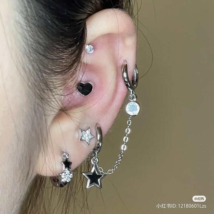 a woman wearing ear piercings with stars and moon charms