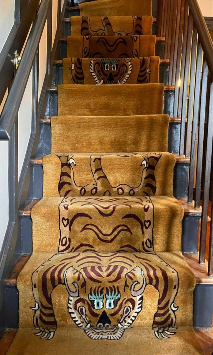 a set of stairs decorated with tiger rugs