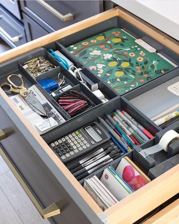 an organized drawer in a kitchen with scissors and other office supplies