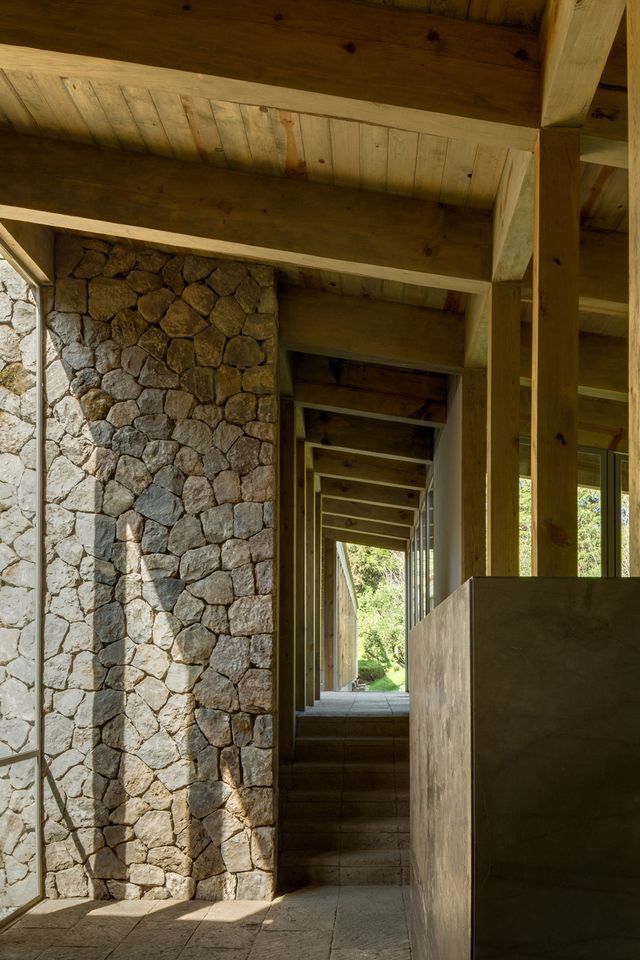 the inside of a building with stone walls and stairs leading up to an open door