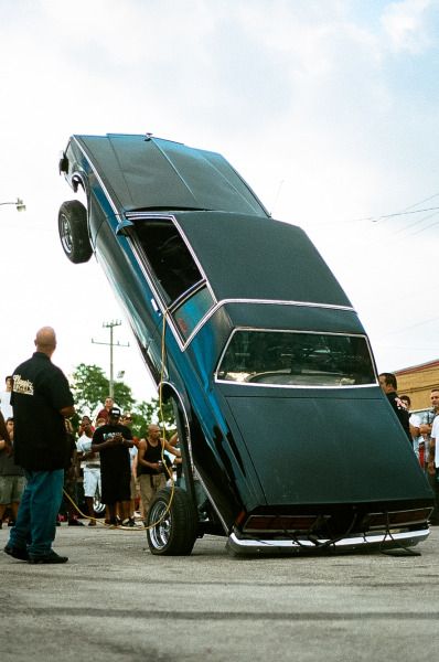 a man standing next to a very large car