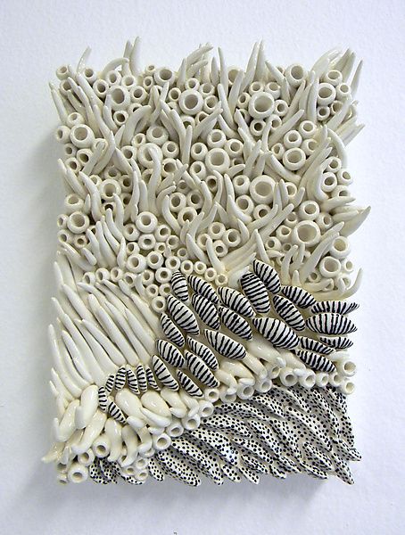 an intricately designed piece of art made out of white plastic and silver metal wire