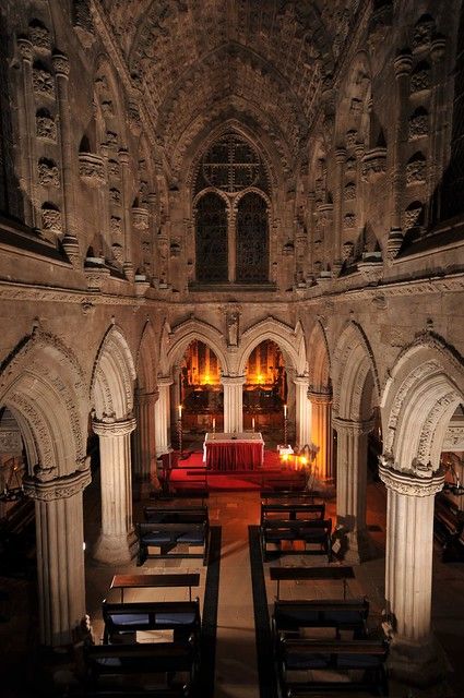 the interior of an old church with pews