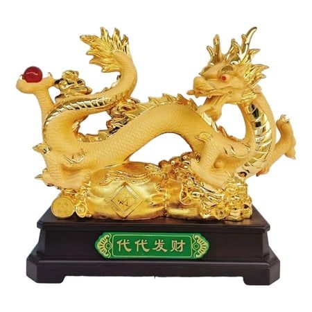 a golden dragon statue sitting on top of a wooden base with chinese writing below it