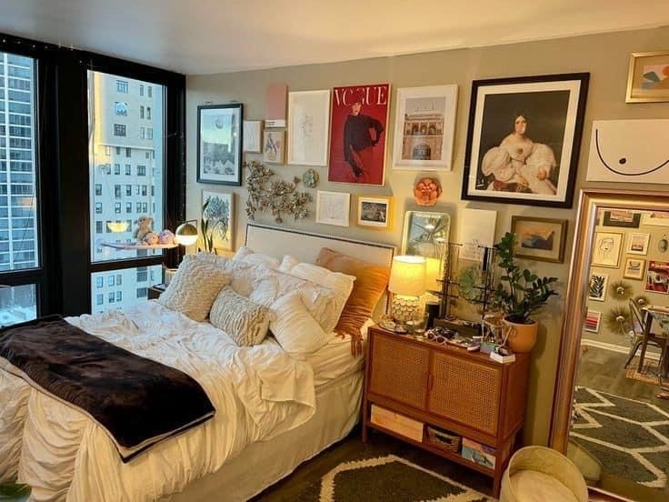 a bedroom with a large bed and lots of pictures on the wall next to it