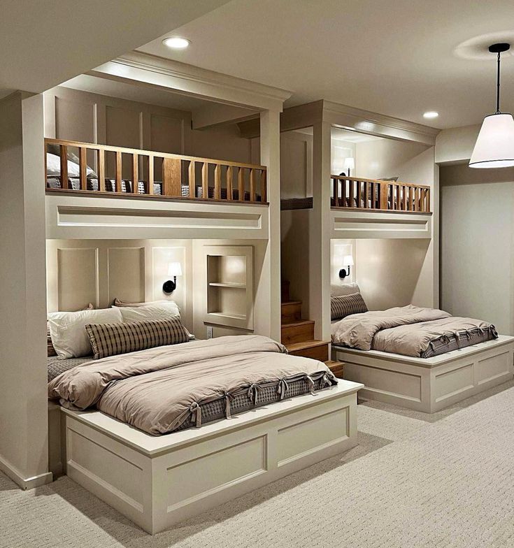 two beds in a room with bunk beds on each side and stairs to the second floor