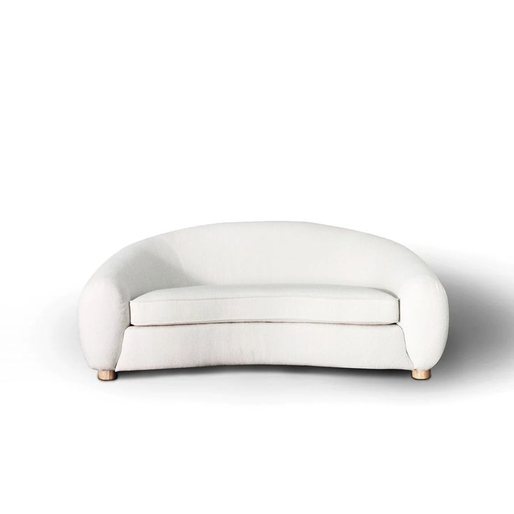 a white couch sitting on top of a white floor