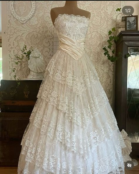 a white wedding dress on display in front of a mirror