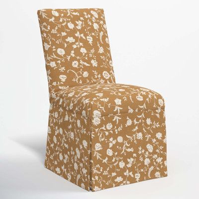 a brown and white floral print chair