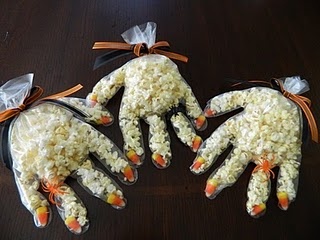 three hands made out of rice with candy corn on them