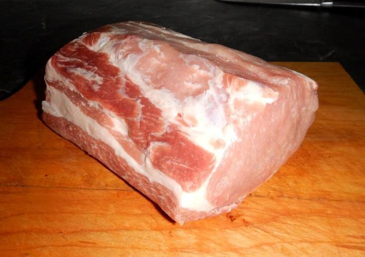 a piece of meat sitting on top of a wooden cutting board