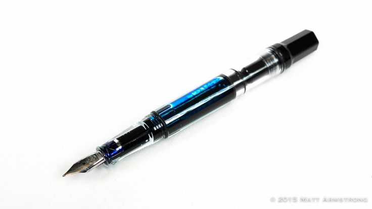 a fountain pen sitting on top of a white table