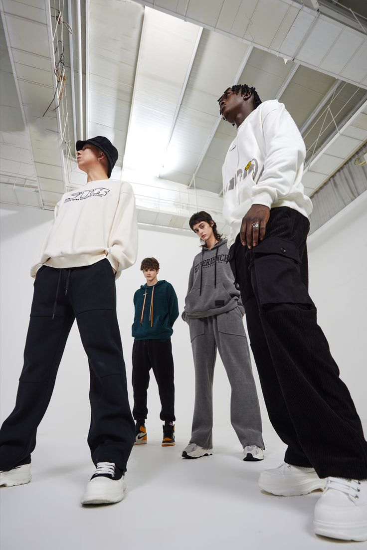 five young men standing in a white room