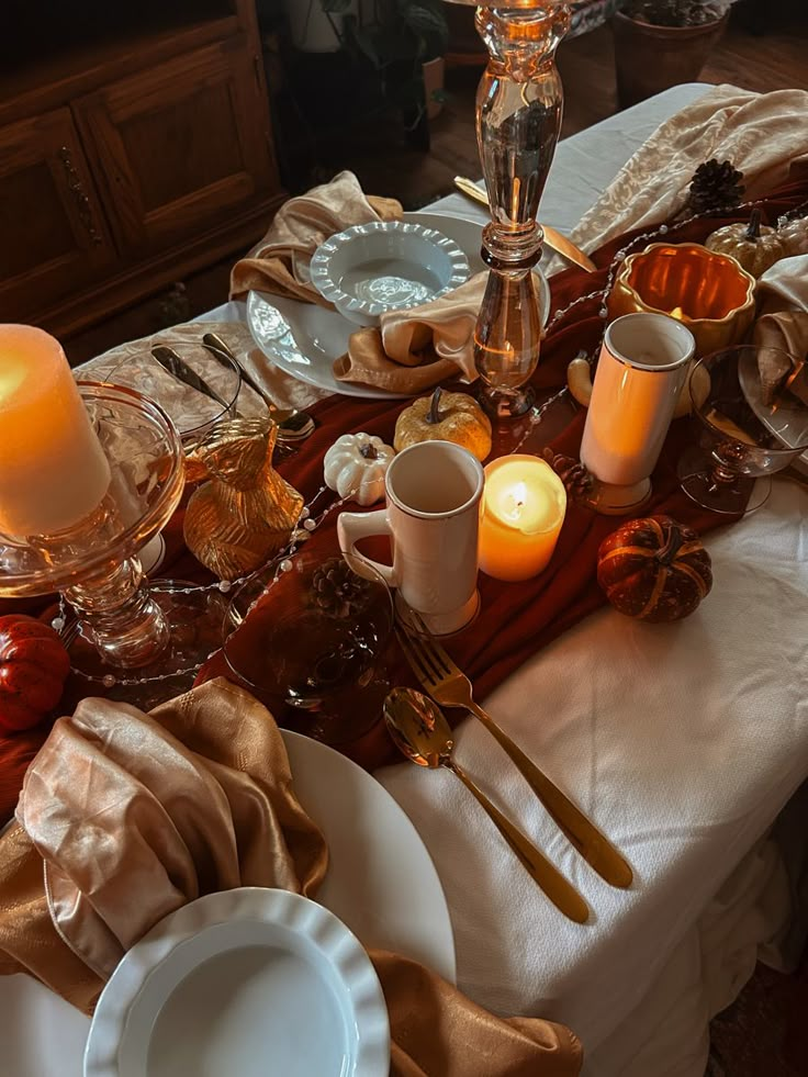 the table is set with candles and dishes