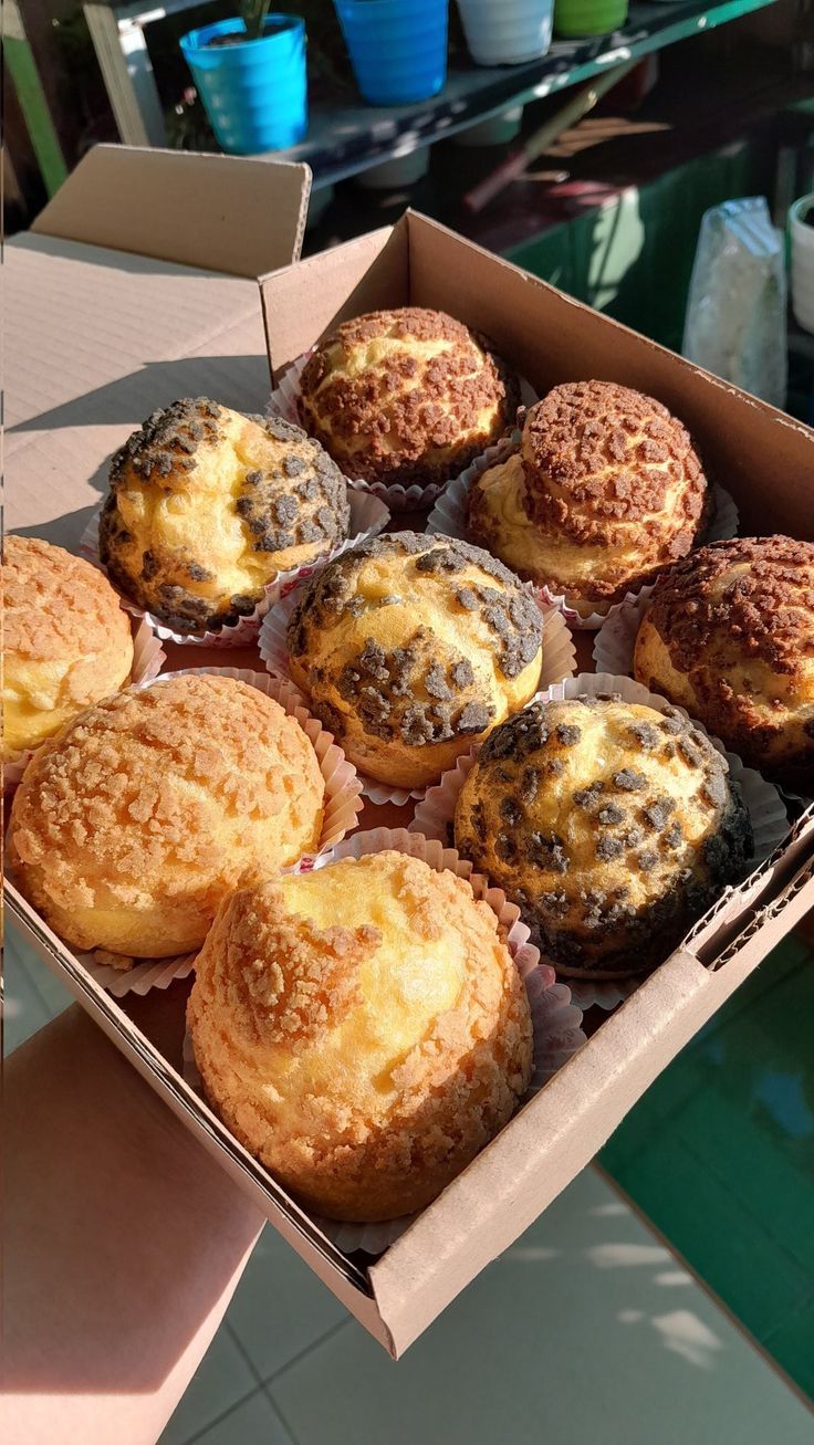 a box filled with muffins sitting on top of a table