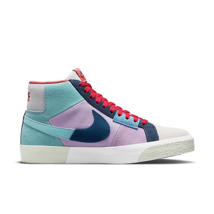 The Nike SB Skateboard Zoom Blazer Mid PRM is part of the 'Mosaic Pack,' which features a fractured aesthetic inspired by the community art spaces of Barcelona. The upper is made of a combination of turquoise leather, off-white suede, and lavender suede and textile, with chopped-up Swooshes adding to the collage-like effect. The light grey mesh on the tongue and heel tab features a Nike wordmark in multicolor embroidery. Performance benefits include a reinforced ollie zone, Zoom Air cushioning i Nike Skate Shoes, Nike Sb Zoom Blazer Mid, Nike Sb Zoom Blazer, Nike Sb Blazer, Nike Sb Zoom, Blue Tomato, Turquoise Leather, Blazer Mid, Nike Zoom