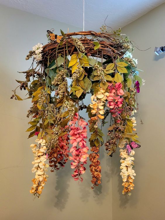 an arrangement of flowers hanging from the ceiling