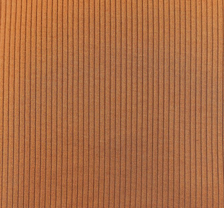 an orange fabric textured with vertical stripes