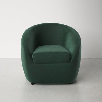 a green chair sitting on top of a white floor