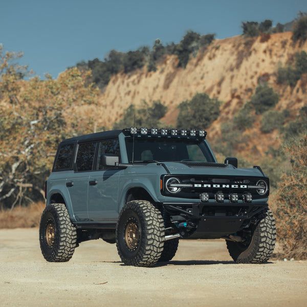 an off - road vehicle is parked in the desert