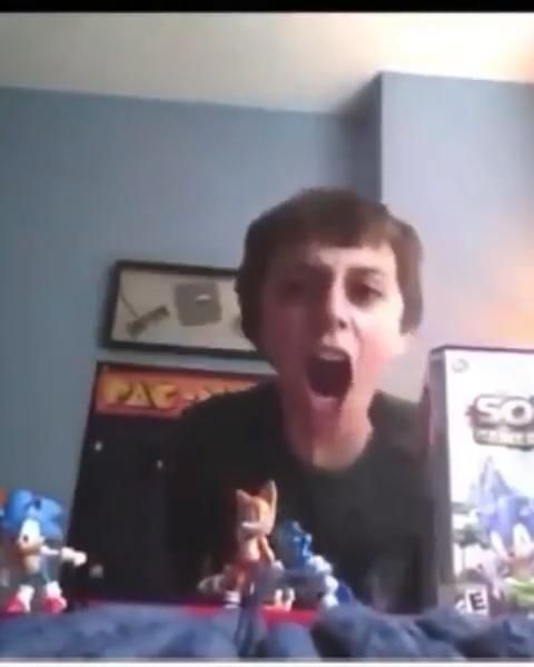 a young man is screaming in front of a video game