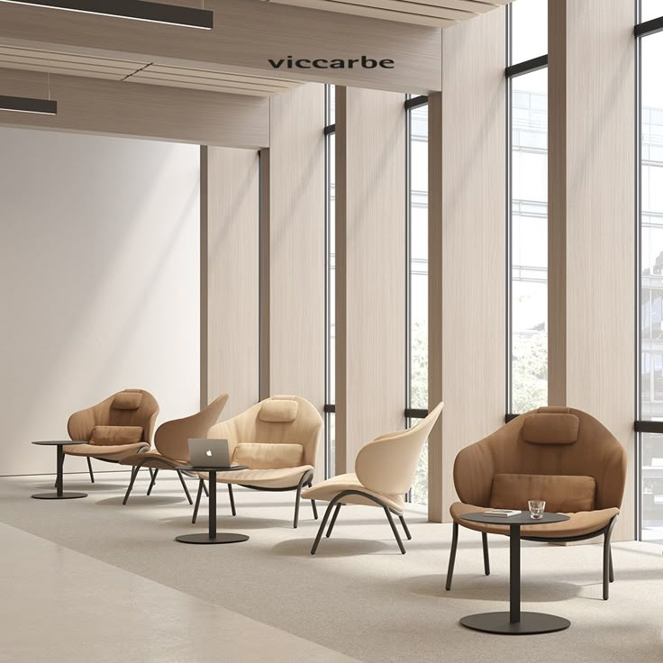 an empty waiting area with chairs and tables in the foreground, people walking by