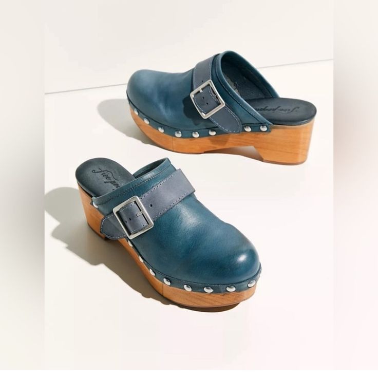 Free People Shoes Culver City Clog Blue Free People So Gorgeous, Spanish-Made Leather Clogs Featured In A Classic Slip-On Design With Studded Trim, A Wooden Platform And A Chunky Buckled Strap. Slip-On Style Lined Footbed Sculpted Platform Split Wood Platform For Added Flexibility And Comfort This Style Runs Small, It In Between Sizes; We Suggest Sizing Up Artisan Crafted From Fine Leathers And Premium Materials Made In Spain Heel Height: 2.76 In Please Note: Label / Tag Has Been Marked To Help Free People Clogs, White Clogs, Block Heel Loafers, Wooden Clogs, Platform Clogs, Culver City, Free People Shoes, Wooden Heel, Leather Clogs