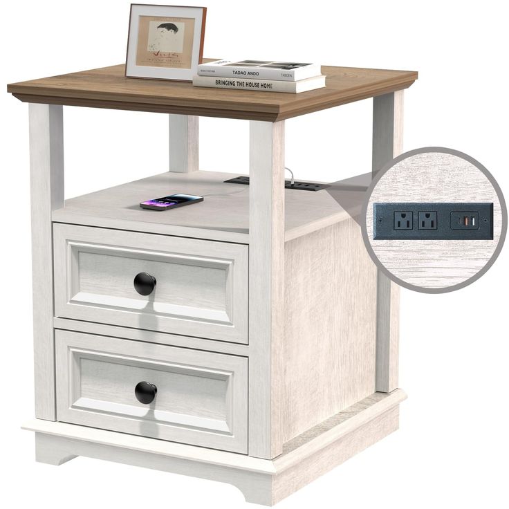 a white nightstand with two drawers and an alarm clock on it's side table