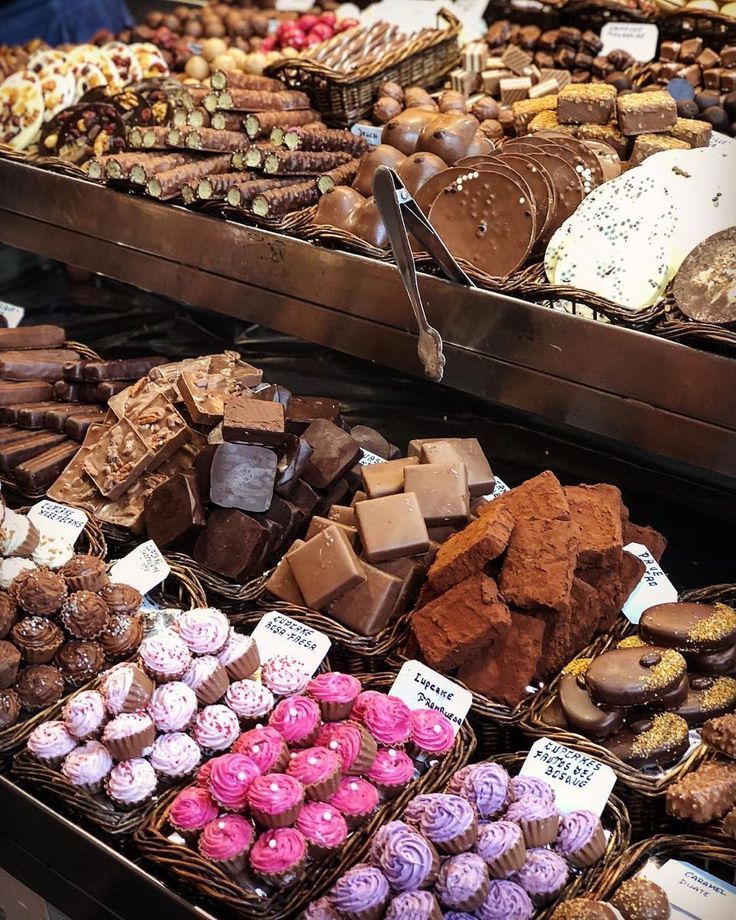 many different types of chocolates and pastries on display