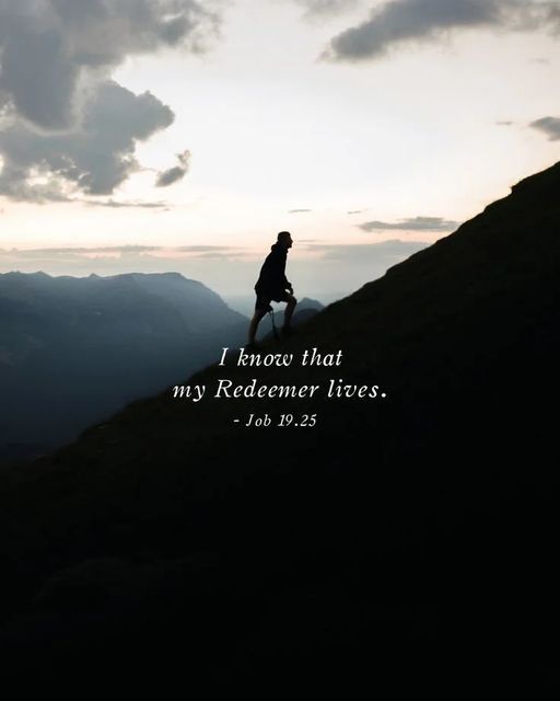 a person sitting on top of a mountain with a bible verse