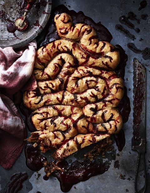 a bunch of pastries that are on a table next to a knife and fork