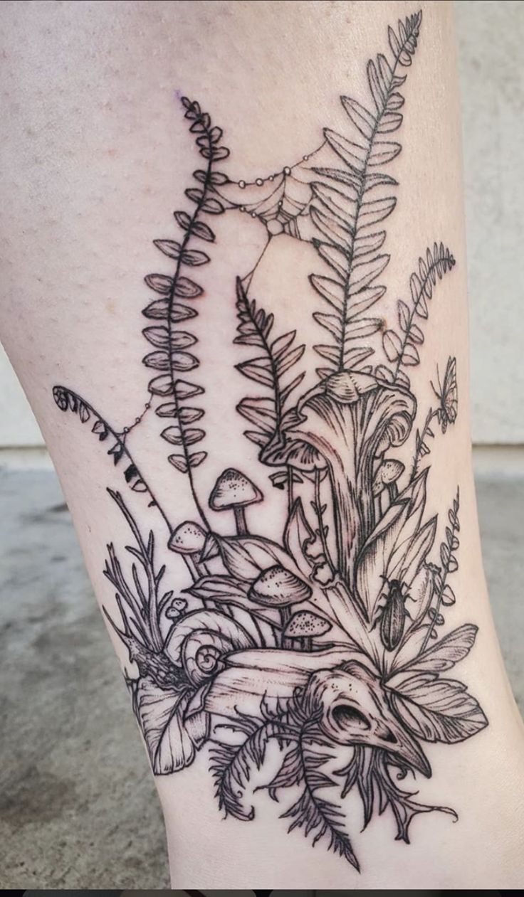 a woman's leg with flowers and plants on it