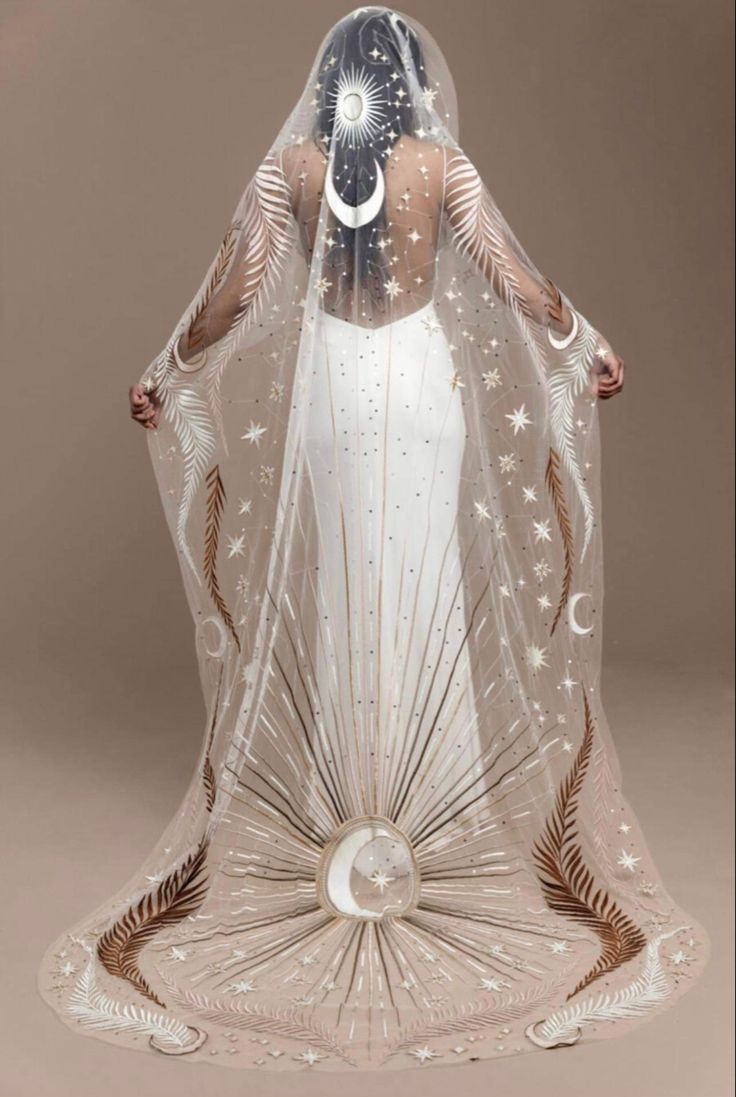 a woman wearing a veil with stars on it