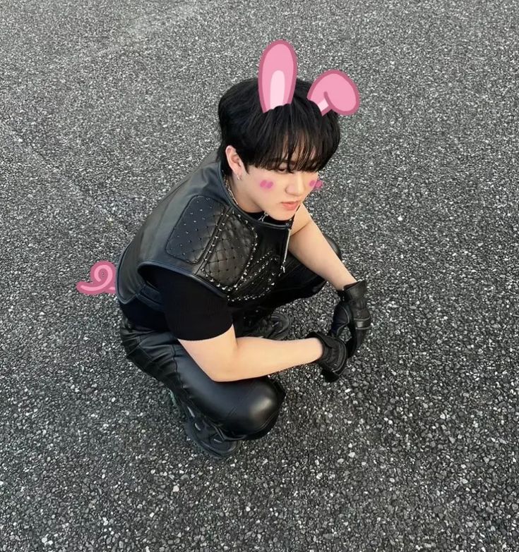 a woman with bunny ears sitting on the ground