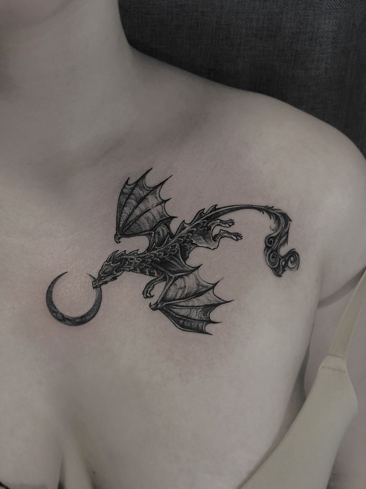 a woman with a dragon tattoo on her chest